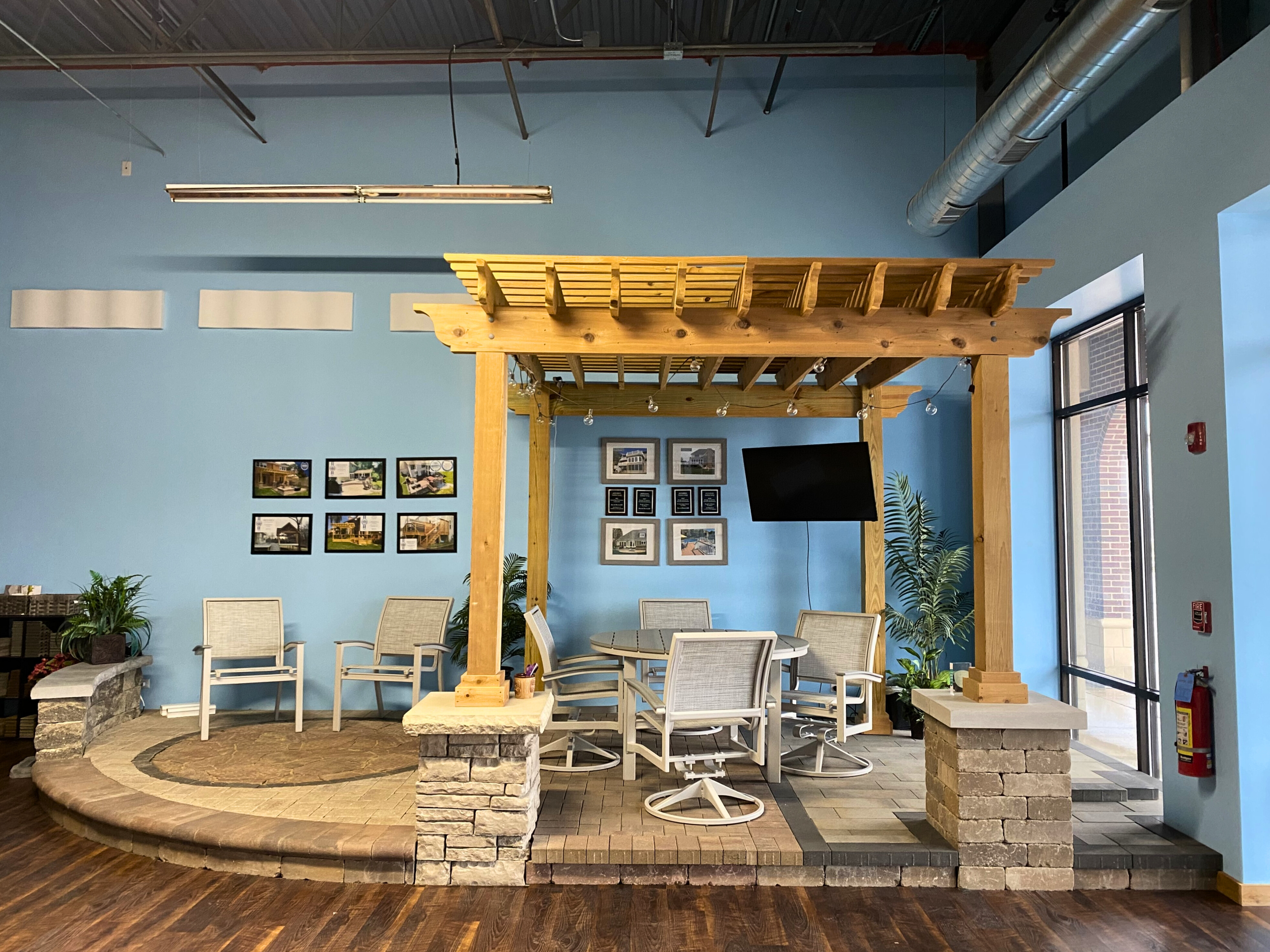 Inside the Archadeck of Naperville design center showing a paver patio and pergola.